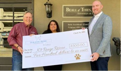 Beall & Thies awarding check to K9 Rouge Rescue